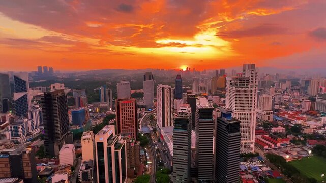 Kuala Lumpur, Malaysia, June 8, 2025: Sunset from an observation deck in Kuala Lumpur. Sunset sky illuminated by twilight, TV tower, and high-rise buildings from the air in the city center. 4K