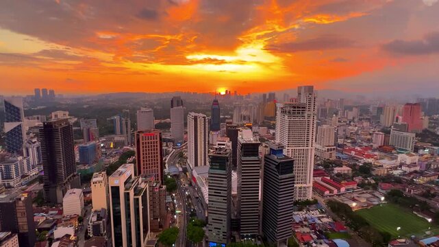 Kuala Lumpur, Malaysia, June 8, 2025: Sunset from an observation deck in Kuala Lumpur. Sunset sky illuminated by twilight, TV tower, and high-rise buildings from the air in the city center. 4K