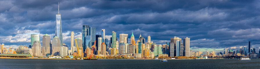 Fototapeta premium Lower Manhattan skyline across New York Harbor with Freedom Tower, NYC