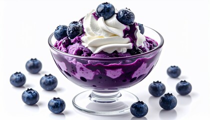 A glass bowl of blueberry dessert topped with whipped cream and scattered fresh berries