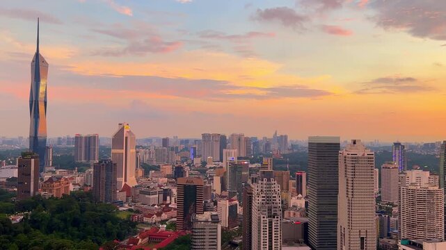 Kuala Lumpur, Malaysia, June 8, 2025: Sunset from an observation deck in Kuala Lumpur. Sunset sky illuminated by twilight, TV tower, and high-rise buildings from the air in the city center. 4K