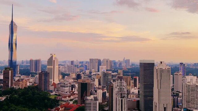 Kuala Lumpur, Malaysia, June 8, 2025: Sunset from an observation deck in Kuala Lumpur. Sunset sky illuminated by twilight, TV tower, and high-rise buildings from the air in the city center. 4K