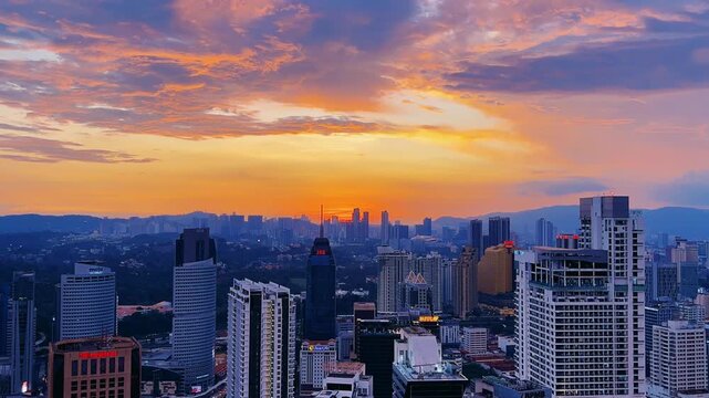 Kuala Lumpur, Malaysia, June 8, 2025: Sunset from an observation deck in Kuala Lumpur. Sunset sky illuminated by twilight, TV tower, and high-rise buildings from the air in the city center. 4K