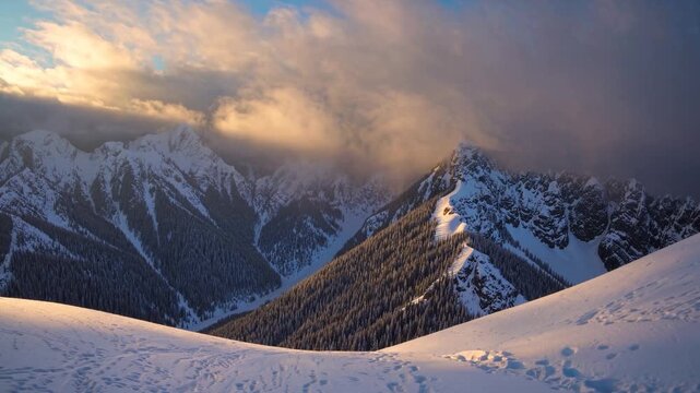 Towering mountains rise majestically against a backdrop of dynamic clouds, softly illuminated by the setting sun. Lush evergreen trees blanket the mountain slopes, creating a seren