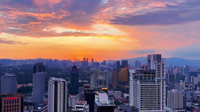 Kuala Lumpur, Malaysia, June 8, 2025: Sunset from an observation deck in Kuala Lumpur. Sunset sky illuminated by twilight, TV tower, and high-rise buildings from the air in the city center. 4K