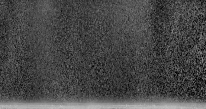 Heavy Rain Falling on a Dark Background with Splashing Water.