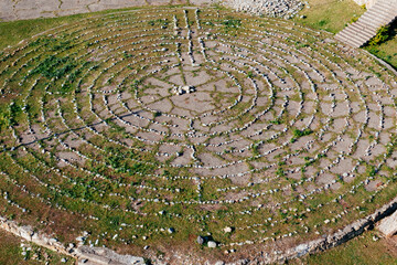Round spiral labyrinth made of stones, top view from drone