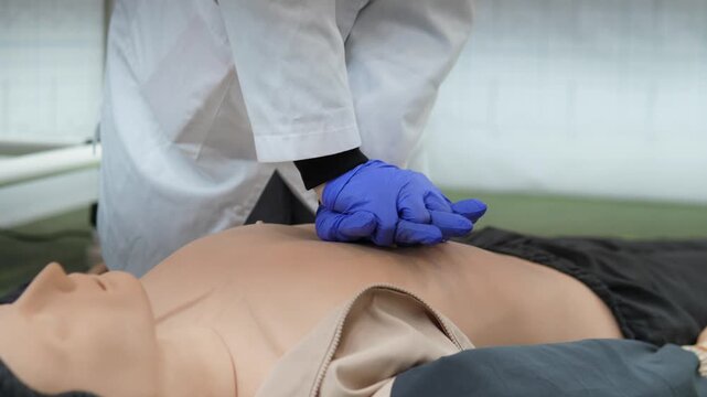 medical team in white coats performing advanced life support on mannequin with bag valve mask and chest compressions, clinical training environment, coordinated airway and circulation