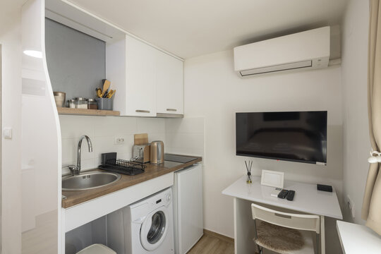 Interior of a very small apartment with a combined kitchen and workspace