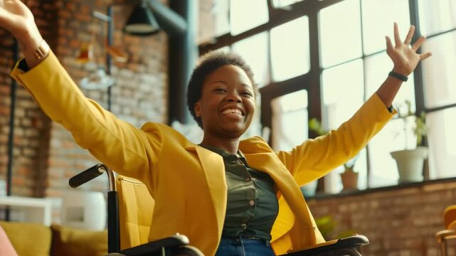 Smiling woman with arms raised in triumph while seated in wheelchair