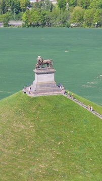 complete monument visitors heading stairs green grass trees open fields lion's mound waterloo belgium to left right down drone panning shot leeuw van captivating 