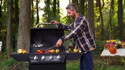 Relaxed weekend vibe with grill and barbeque. Calm barbeque scene with mature man. Grill barbeque and chill in nature. Barbeque and rest near smoky grill. Weekend relaxation with grilled food.