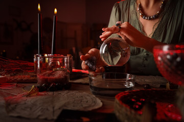 Fortune teller with crystal ball reading future  at table