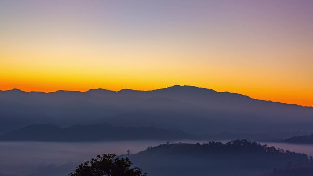 Time lapse beautiful sun shine above the mist in the valley
slow floating fog blowing cover on the top of mountain look like as a sea of mist. 
white cloud in blue sky over the perfect forest.