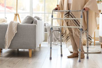 Senior woman with medical walker at home