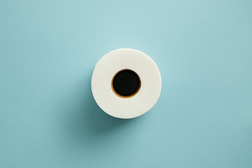Minimalist top view of white coffee cup filled with black espresso placed on pastel blue background with negative space