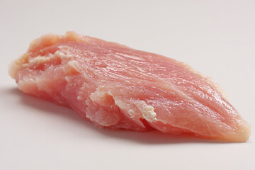 Fresh chicken breast on a white table