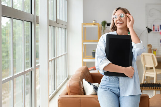 Beautiful female web designer with graphic tablet in office - Powered by Adobe