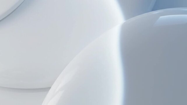 Close-up of white rounded objects with soft shadows and a shallow depth of field on a light blue