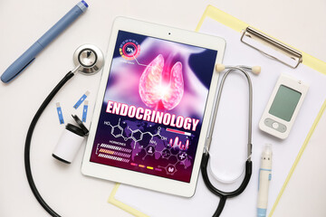 Tablet computer with open endocrinology app and medical supplies on white background