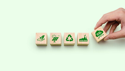 Sustainable business and carbon reduction concept with eco friendly wooden blocks showing renewable energy, recycling, green industry and CO2 management for ESG strategy