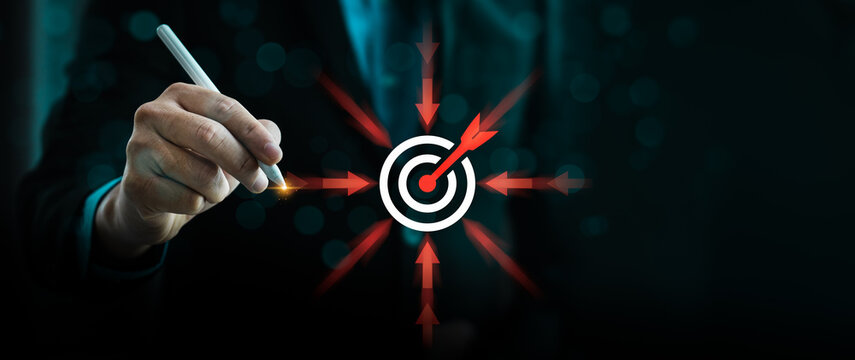 businessman highlighting a central target icon with arrows pointing inward, symbolizing business focus, strategic direction, goal-setting, precision, and effective decision-making for success