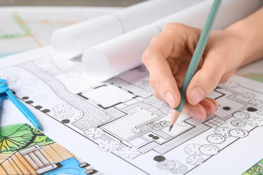 Woman drawing zoning plan, closeup