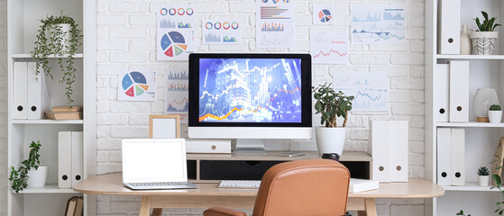 Interior of data scientist's office with workplace, diagrams and shelf units