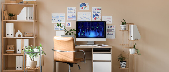 Interior of data scientist's office with workplace, diagrams and shelf unit