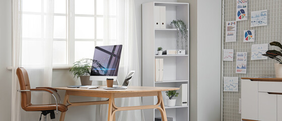 Interior of light data scientist's office with workplace