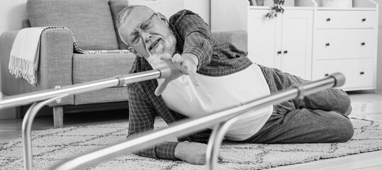 Senior man lying on floor after fall with walker at home