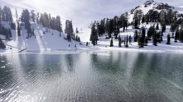 Snow covered landscape surrounding the Ridge Lake with icy volcanic peaks at Lassen Volcanic National Park