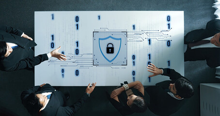 A professional business team engages in a strategic meeting focused on cybersecurity, featuring a digital lock and binary code on a modern conference table. Trope