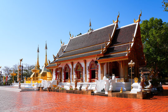 Golden stupa and Lanna-style temple architecture at Wat Phra That Doi Tung temple near Chiang Rai, Northern Thailand