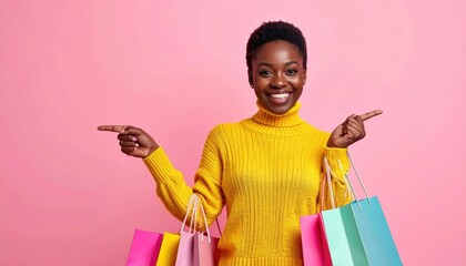 Portrait of cheerful young asian woman holding colorful shopping bags and pointing finger at copy space on pink background. Retail concept