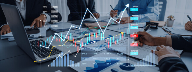 A dynamic business team engaged in financial analysis using a laptop, discussing growth strategies while reviewing charts and data in a collaborative office setting. Scalp