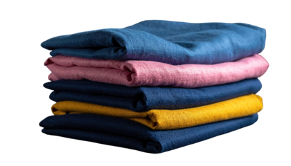 A stack of folded fabric in various colors, arranged neatly. The textiles exhibit slight texture and shadows