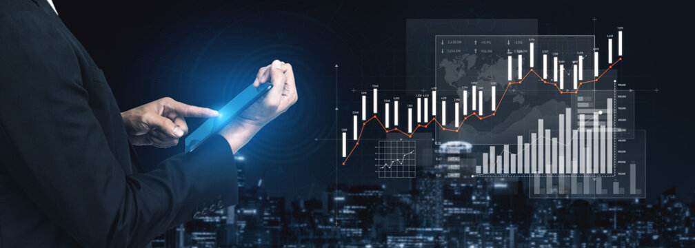 Business professional interacts with a tablet, analyzing financial data and growth trends in an urban setting, emphasizing modern technology in finance. Scalp - Powered by Adobe