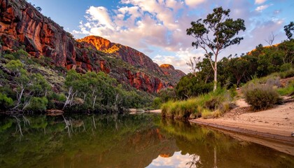 Scenic river landscape with rugged red rock cliffs and green trees reflecting on calm water. Nature concept