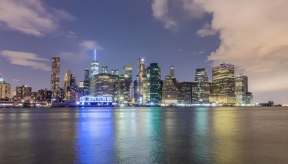 Panoramic city skyline features illuminated modern skyscrapers reflecting on calm water at night. Urban concept