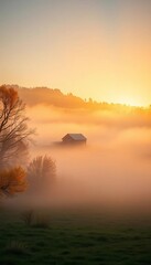 Misty autumn morning over a distant barn, warm light breaking through fog,  harvest,  countryside