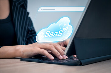 SaaS technology concept showing female hands using cloud-based software service via tablet. Software as a Service for business operations, digital transformation, and scalable online solutions.