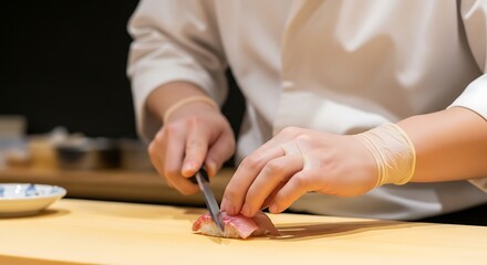 Obraz premium Chef Preparing Sushi with Knife in Modern Kitchen