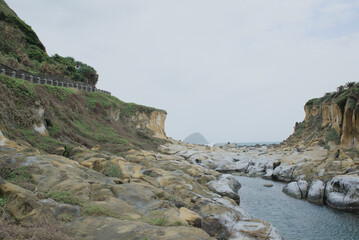Majestic sandstone cliffs and eroded rock formations along the coastal valley of Heping Island Park, Keelung, Taiwan.