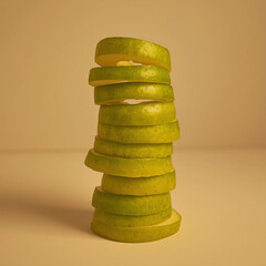 Stacked Slices of Fresh Green Apple or Pear on Duo-Tone Background