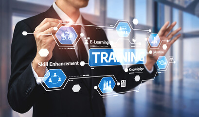 A business professional interacts with digital training graphics in a modern office, representing the importance of e-learning and skill enhancement in the workplace. Tessel