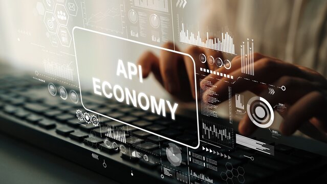 Hands Typing on Keyboard with Overlay of Digital Graphics Representing API Economy and Technology Trends. Asymptotic smart data analytic. - Powered by Adobe