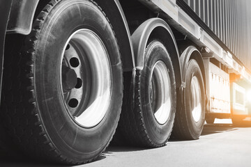 Semi Trailer Trucks on The Parking Lot at Sunset. Big Rig. Tractor Truck. Truck Wheels Tires. Shipping Container. Shipping Import- Export. Trucking. Freight Truck, Logistics Cargo Transport.