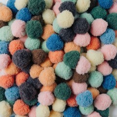 Colorful handmade pom-poms in vibrant pastel and bold tones create playful textured background &mdash; ideal for crafts, kids, or festive designs