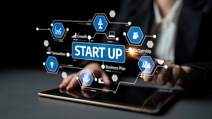 A business professional engages with a tablet, visualizing key start-up themes such as innovation, growth, and partnership, essential for aspiring entrepreneurs. Tessel